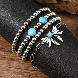 Detailed macro shot of vintage silver beaded bracelets with turquoise and butterfly pendant