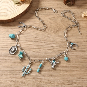 Bohemian silver necklace with turquoise beads and western charms like cactus and horseshoe