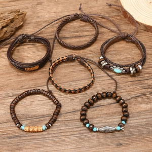 Close-up of 6-piece men's vintage leather wrap bracelets with wooden beads and metal charms