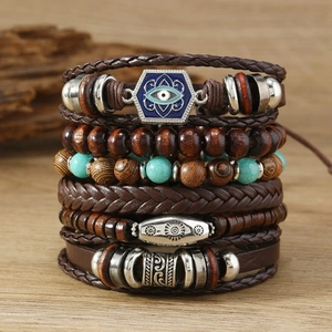Detail of bohemian leather bracelet set with turquoise beads and evil eye charm