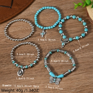 5-piece Bohemian beaded bracelet set with turquoise beads and western charms on wood