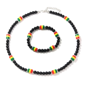 Detail of bohemian black seed bead necklace and bracelet set with reggae color accents