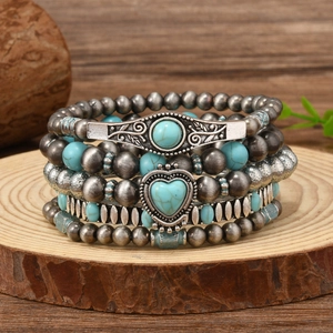 Bohemian multi-layer turquoise bead bracelet with vintage silver heart pendant on wood