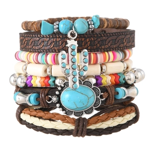 Close-up of Bohemian layered bracelets with turquoise beads and cactus charm detail