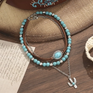 Detail van de bohemien gelaagde ketting met turquoise kralen en cactus hanger