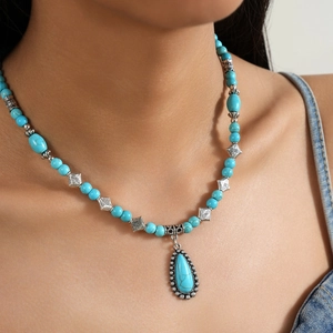 Bohemian turquoise beaded necklace with water drop pendant on a female model