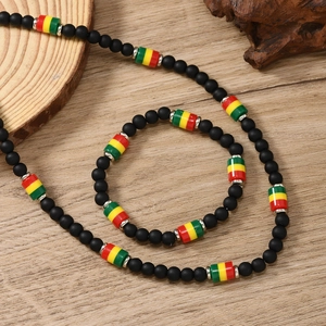 Close-up of bohemian matte black beaded necklace and bracelet set on wood