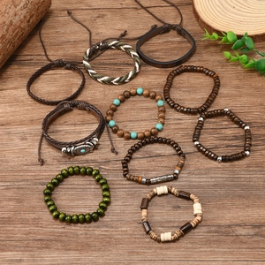 Detailed flat lay of bohemian leather and beaded bracelet sets on a rustic wood surface
