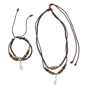 Close-up of ethnic braided jewelry set with treble clef charms and colorful wooden beads
