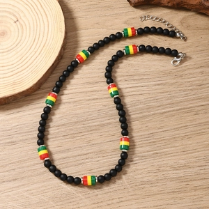Close-up of Rasta style beaded necklace with matte black beads and adjustable metal clasp