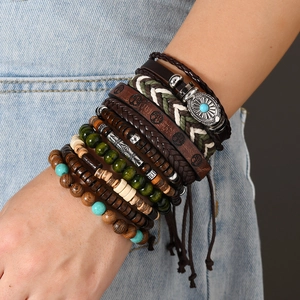 Detail of bohemian layered bracelets with leather cords, wood beads, and tree of life charm