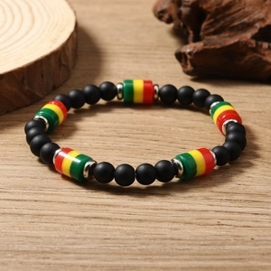 Close-up of bohemian beaded necklace with red yellow and green beads on wood surface