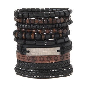 Close-up of multilayer leather bracelet with cross-engraved metal plate and wood beads