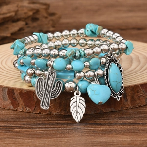 Detail of bohemian turquoise beaded bracelets with silver cactus and leaf pendants
