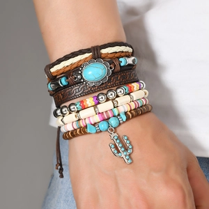 Detail of bohemian layered bracelets with turquoise beads and silver cactus charm