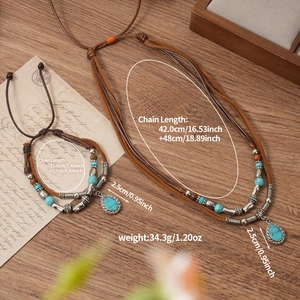 Detail of bohemian layered necklace and bracelet set with turquoise beads and charms