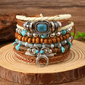 Close-up of Bohemian multilayer leather bracelet with turquoise and crescent pendant