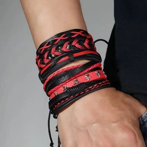 Detail of multi-layer leather braided bracelet with red and black cord and star rivets