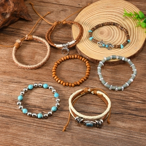 Detail of bohemian turquoise beaded bracelets with wooden rings on a rustic background