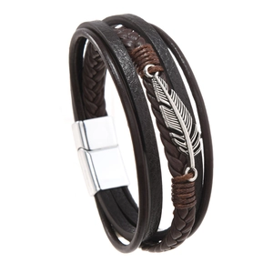Detail of multi-layer leather bracelet featuring a silver feather charm and magnetic clasp