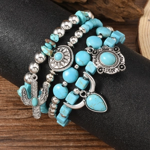 Detail of Bohemian beaded bracelet set featuring turquoise stones and cactus charms