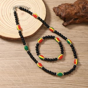 Detail of bohemian reggae style colorful beaded necklace and bracelet on wood