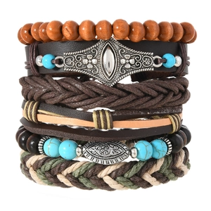Macro shot of multilayered leather bracelets with wood beads and vintage alloy charms