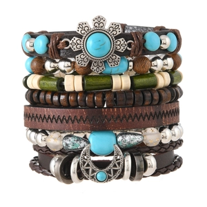 Detail of bohemian multilayer bracelet set with leather, wood beads and metal charms