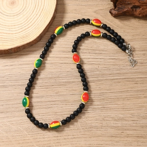 Detailed shot of ethnic beaded necklace with matte black beads and colorful glaze accents