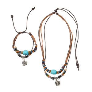 Detail of bohemian wolf tooth style ethnic necklace and bracelet set with blue beads