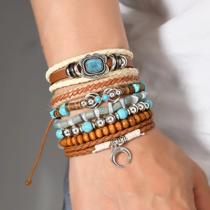 Detail of bohemian multilayer bracelet featuring turquoise beads and vintage metal charms