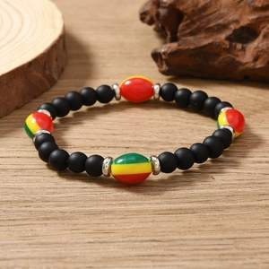 Macro shot of Rasta style beaded bracelet with matte black beads and colorful accents
