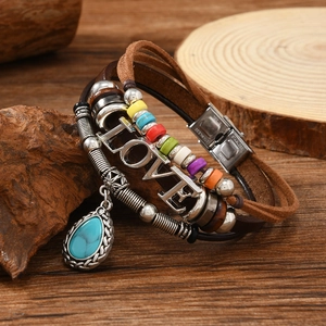 Detail of bohemian leather bracelet with turquoise pendant and stainless steel clasp