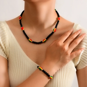 Detail of bohemian black matte bead necklace set with colorful reggae style accents