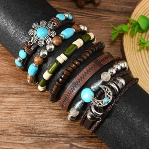 Detail of bohemian leather bracelets with wood beads and sun moon charms on display