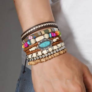Detail of bohemian layered bracelet with turquoise center and woven leather texture