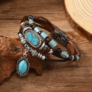 Macro detail of multi-layer leather bracelet with turquoise stones and steel clasp