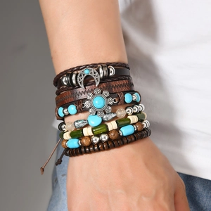 Detail of bohemian layered leather bracelet with wooden beads and silver moon charm