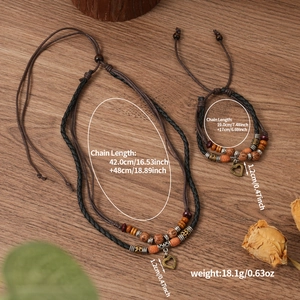 Detail of vintage multilayer woven heart pendant necklace and bracelet set with beads