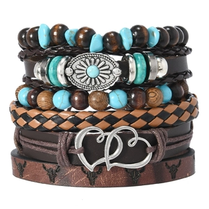 Detail of vintage bohemian leather bracelet with bull skull print and wood beads
