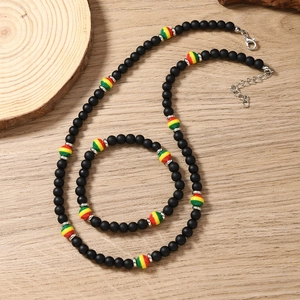 Detail of bohemian necklace and bracelet set with black matte beads and colorful accents