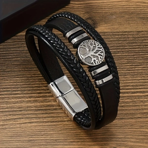 Detail of men's multilayer braided leather bracelet with Tree of Life charm and magnetic clasp