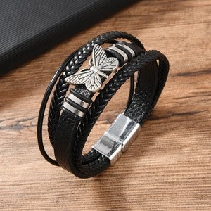 Multi-layer black braided leather bracelet with vintage silver butterfly charm on wood