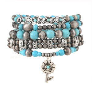 Bohemian multi-layer turquoise bead bracelet with vintage silver charms and floral pendant
