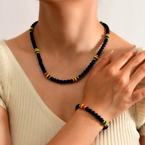 Detail view of Bohemian matte black beaded necklace and bracelet set on a female model