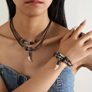 Close-up of bohemian double-layer woven necklace and bracelet set with tribal charms
