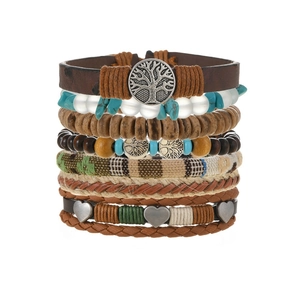 Detail of bohemian multilayer bracelet with turquoise beads and tree of life charm