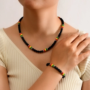 Detail of beaded choker necklace and bracelet set with red yellow green matte beads