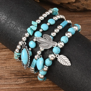 Detail of bohemian multilayer beaded bracelets with turquoise stones and silver pendants