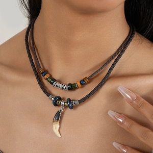 Close-up of bohemian double-layer woven necklace with ethnic pendant and colorful beads